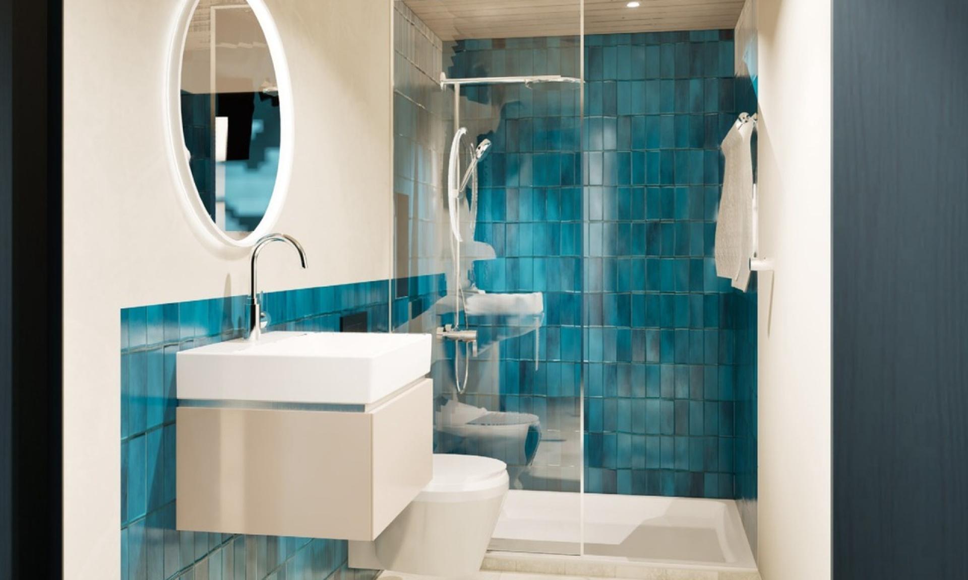 Badezimmer mit blauen Fliesen und begehbarer Dusche im Schiffli Boutique Apartment Rapperswil